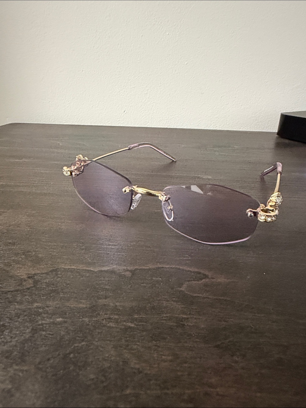 Elegant Rimless Women's Sunglasses with Gold Accents - Purple Lenses